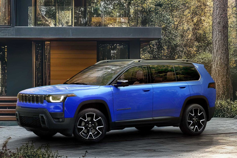 2026 Blue Jeep Cherokee SUV parked in a driveway outside a modern forest home