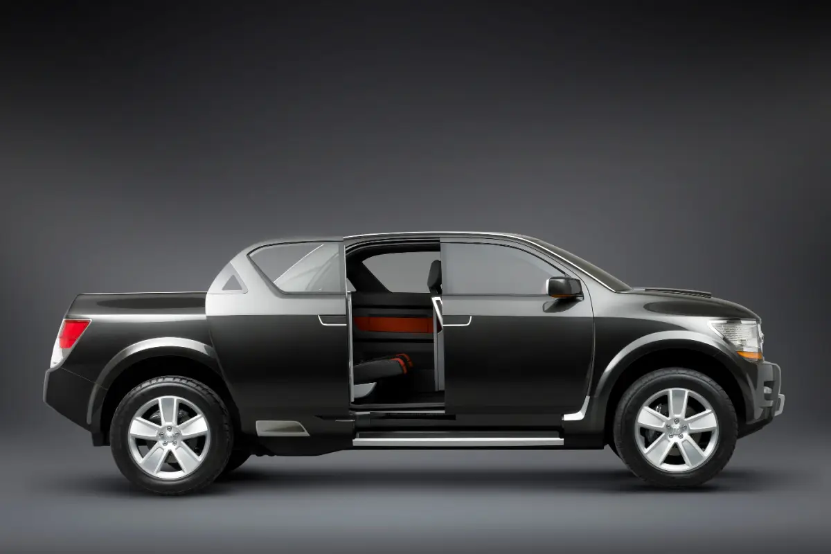 2026 Black Dodge Rampage concept pickup truck side profile view in a studio setting with open cab door